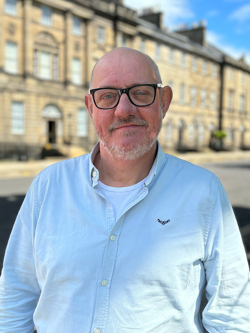 Headshot of John Penman standing on Charlotte Square.