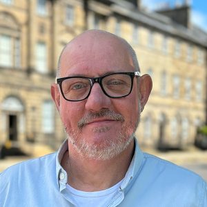 Headshot of John Penman standing on Charlotte Square.