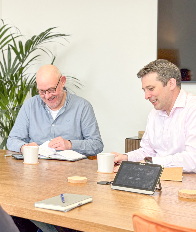 Anthony and John, 56 Degrees North founders, sit together at the boardroom table.