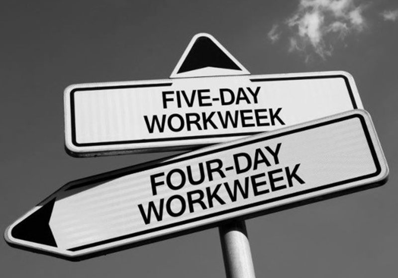 Two road signs with "five-day workweek" and "four-day workweek" on them