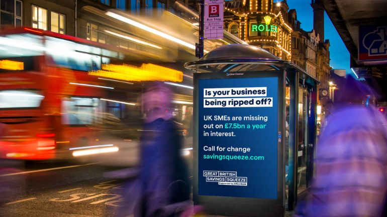 Allica Bank billboard on a bus shelter on a busy london street.