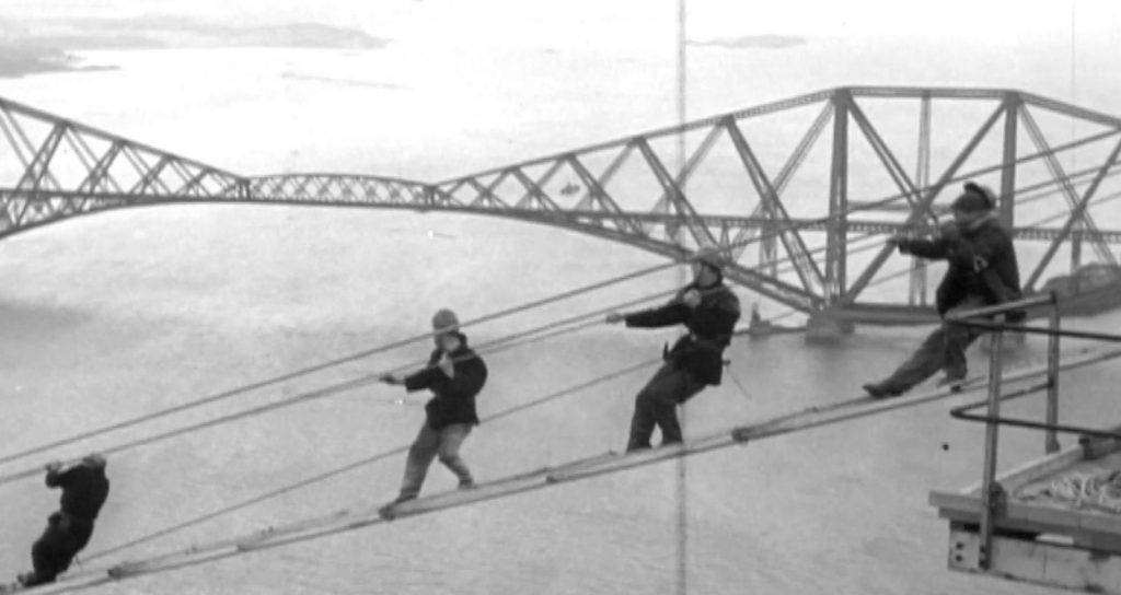 Black and white image of builders on the beginnings of the Forth Road Bridge. Illustrating a story about much needed improvements to Scottish transport.