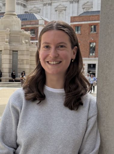 India Willsher wearing a grey jumper standing in front of a square in London.